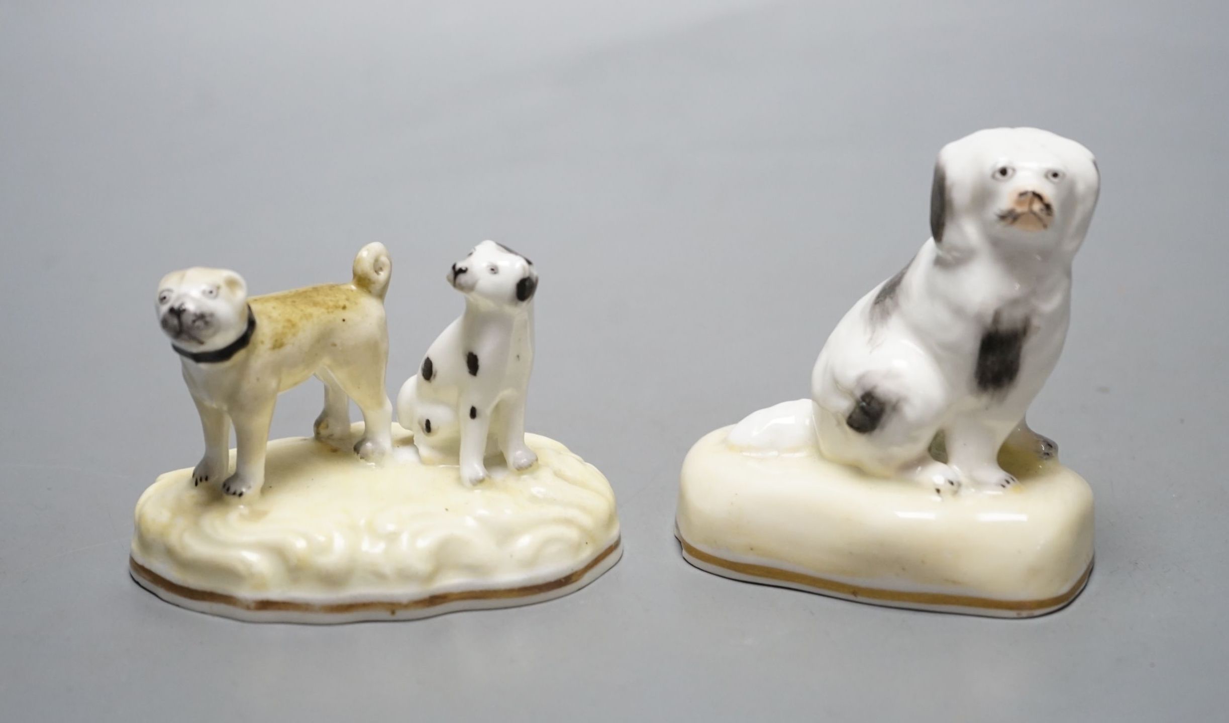 A Samuel Alcock porcelain a group of a pug dog and a spaniel, c.1835-50, together with a similar figure of a seated spaniel, impressed marks 342 and 183. Cf. Dennis G.Rice Dogs in English porcelain, colour plate 36 and f